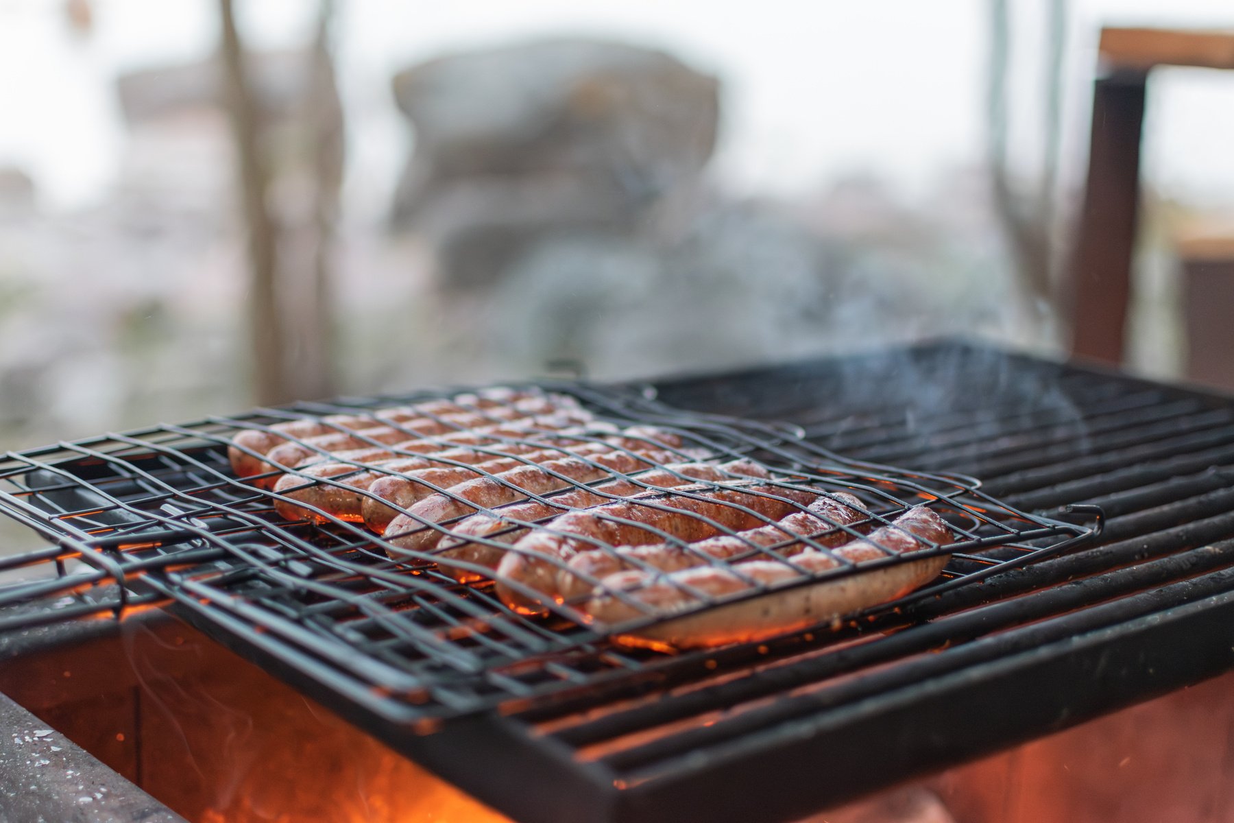 sausages in barbecue grill on barbecue